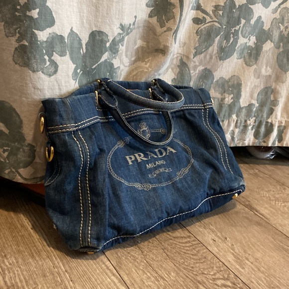 This is a Prada denim tote bag. No rips or tears, just minor wear from use. - Picture 2 of 9